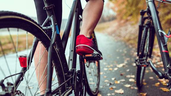 Die Beine eines Radfahrers, der in die Pedale tritt