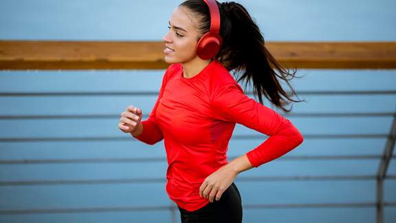 Eine junge Frau joggt mit Kopfhörern